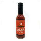 A 148ml bottle of Butterfly Bakery of Vermont Smoked Serrano Squash Reaper Pepper X Hot Sauce on a white background.