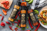 Flat-lay image of three of Grumpy Gary's superhot sauces - Butt Tickler; The Ripper; Burns Twice.