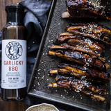 Grumpy Gary's Garlicky BBQ sauce bottle with ribs on a tray