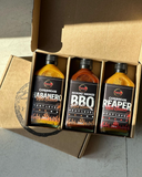 3 bottles of Pepper by Pinard sauces inside the gift box.