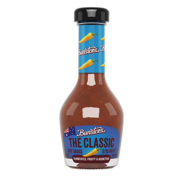 Bottle of Bunsters The Classic hot sauce with blue label and black cap on white background