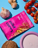 30g sachet of Aunty Jenny Mild Curry blend on a table surrounded by vegetable. Available to buy online in Australia at Blonde Chilli.