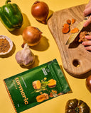 30g sachet of Aunty Jenny Turmeric Powder on the table near a wooden chopping board. Available online in Australia at Blonde Chilli.