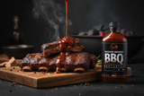 A bottle of Pepper By Pinard Hickory Smoked BBQ Sauce stands beside a wooden board. On the board is a stack of beef ribs, being smothered in the sauce.