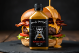 Uncle Mungo's Burger Sauce stands in front of a burger with burger sauce being poured all over it