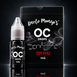 A 10ml bottle of Uncle Mungo's OC Drops next to its black packaging box, on a dark background. Buy online at Blonde Chilli.