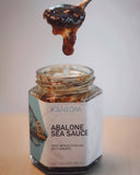 Abalone Sea Sauce. Spoonful of Sauce dripping into the jar.