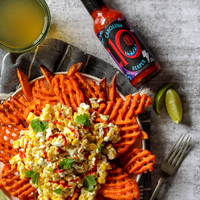 A bottle of Culley's No 10 Carolina reaper Hot Sauce lies beside a platter of sweet potato waffle fries