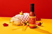 The Classic Hot Sauce Promo Shot. Bottle of Hot Ones Hot Sauce stand beside a burrito. The Classic Hot Sauce. Get it at Blonde Chilli, not Mat's Hot Shop.