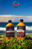 Pepper By Pinard hot sauces sitting on the beach.